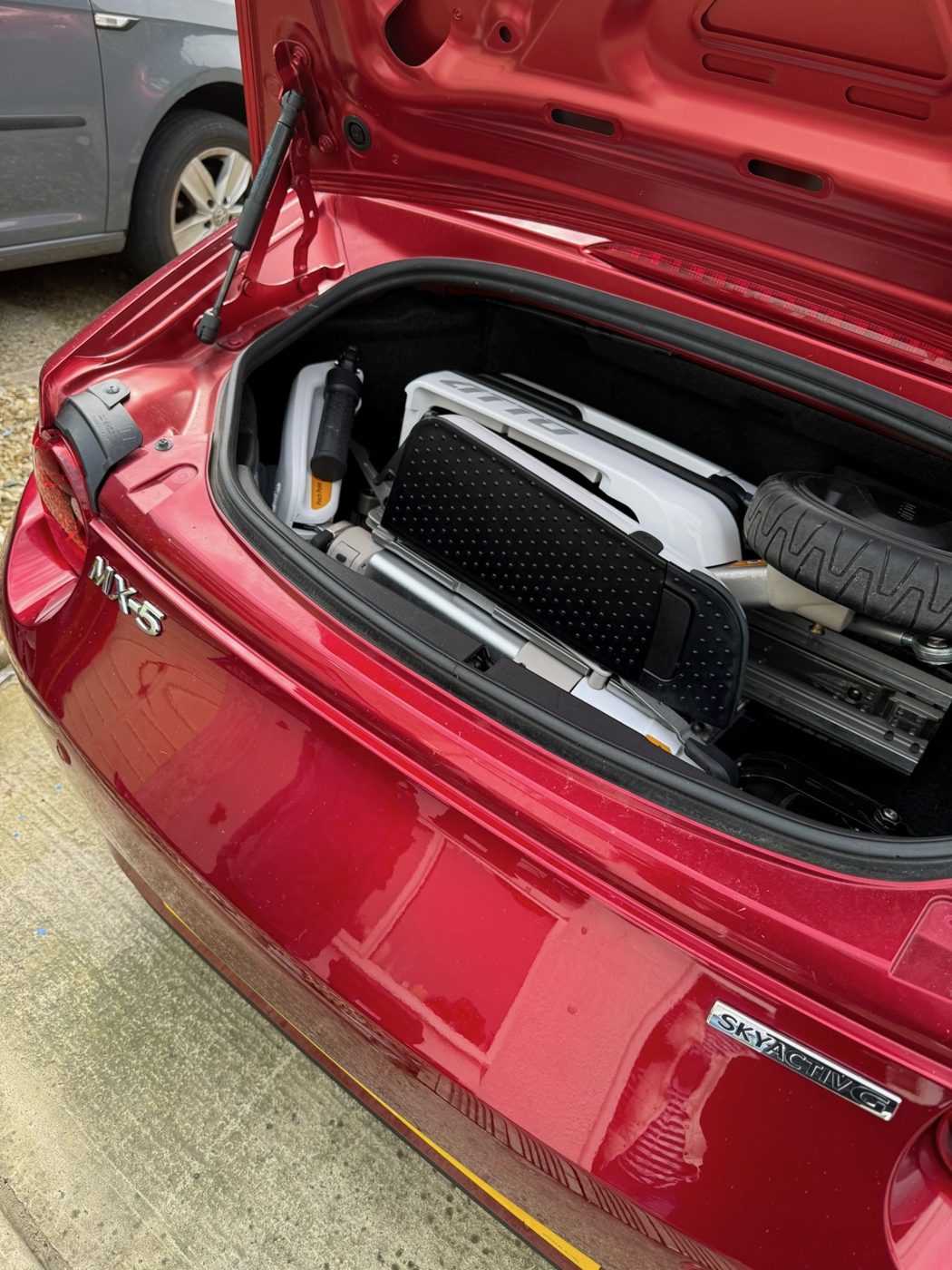 ATTO folding mobility scooter in the boot of a Mazda MX-5 convertible roadster