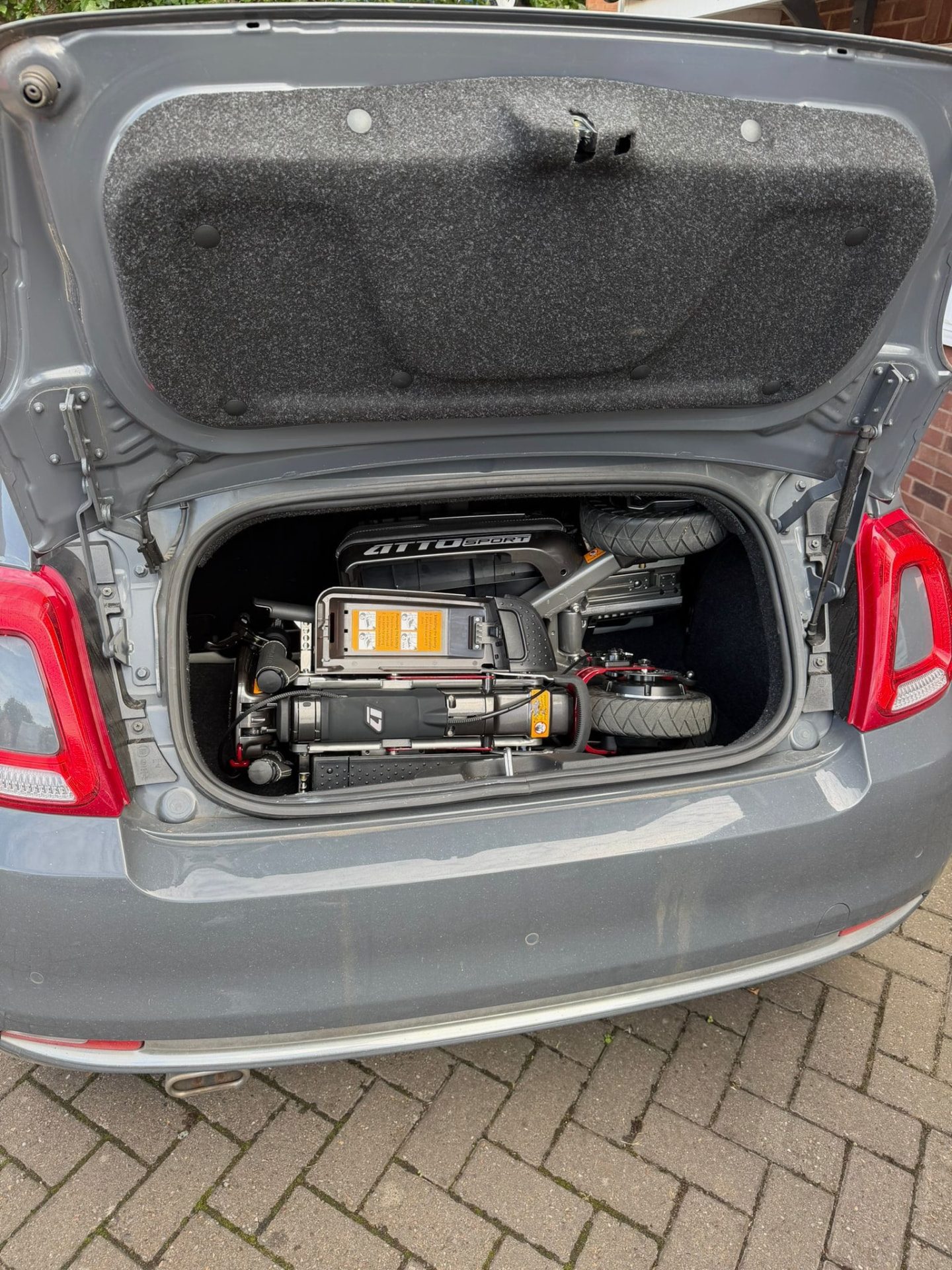 Fiat 500 (2007-2024) boot with a folded ATTO mobility scooter ATTO folding mobility scooter in the boot of a Fiat 500