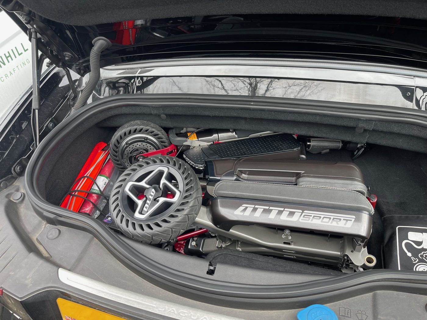 ATTO folding mobility scooter in the boot of a Jaguar F-Type convertible sports car